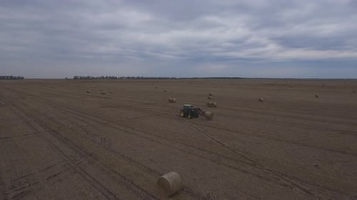 Aerial View of Tractor Working in Rural Field