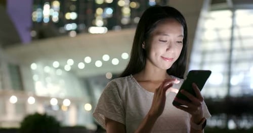 Woman use of mobile phone at night