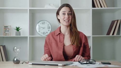 Woman at Desk Talking in Office Environment