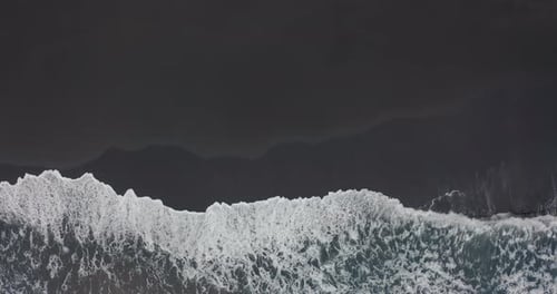 Aerial View, Black Sand Beach. Beautiful Ocean Waves Crashing on Coastline, Natural Volcanic Beach