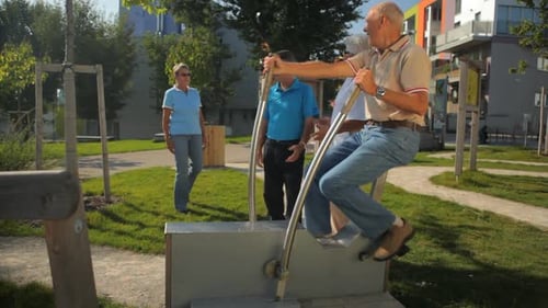 Seniors Exercising on Outdoor Fitness Equipment