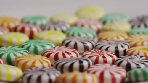 Colorful Round Striped Candies on White Background