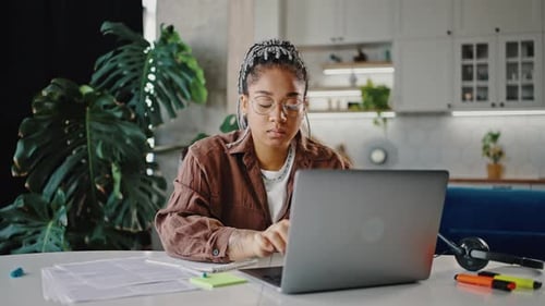 Young Adult Working on Laptop at Home