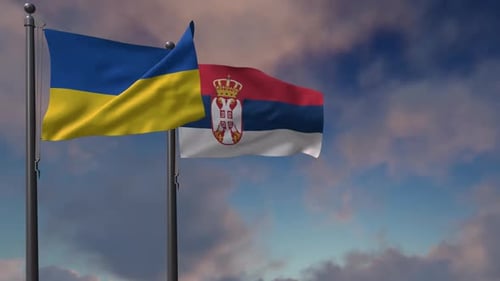 Ukraine and Serbia National Flags Waving on Flagpoles