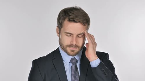 Man with Headache Rubbing Temple in Pain