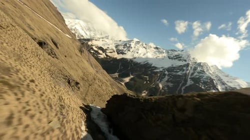 Drone Shot Down a Waterfall Along the Mountain Dew Towards to Beautiful Valley