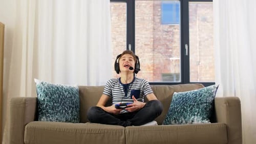 Teen Plays Video Game, Celebrates Victory on Couch