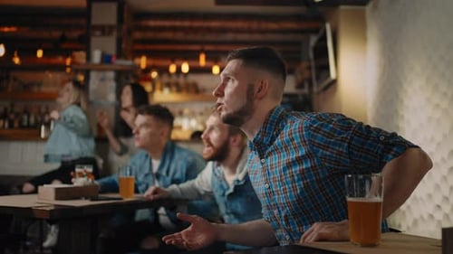 Friends Cheer at Sports Game in a Bar