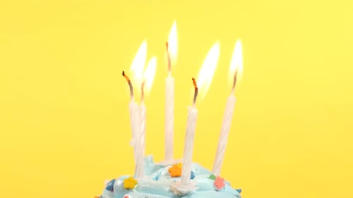 Festive Cupcake With Five Candles on Yellow Background