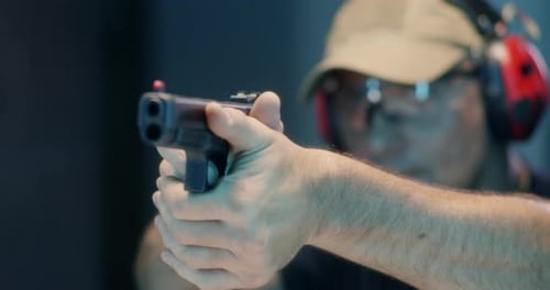Middle Aged Shooter Firing Pistol
