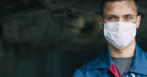 Mechanic Wearing Face Mask in Automotive Repair Shop