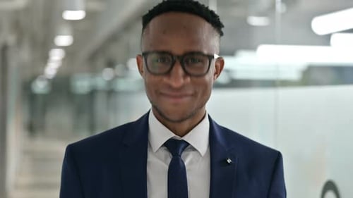 Smiling Young Adult in Suit Jacket and Tie
