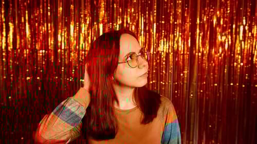 Woman Posing with Hand in Hair, Gold Backdrop