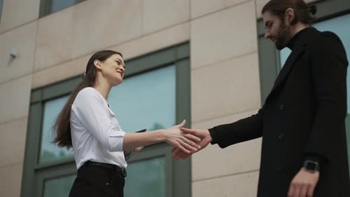 Business Professionals Handshake Outside Modern Building