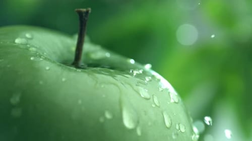 Extreme close-up of water drip on apple in slow motion; shot on Phantom Flex 4K at 1000 fps