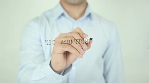 Man Writes SEO Monitoring on a Screen