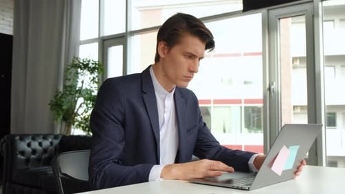 Creative Entrepreneur Sitting at His Desk Works on Desktop Computer in the Stylish Office