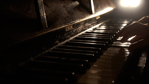 Old Piano Keys Played in Dim Light