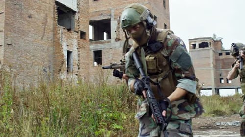 Soldiers Patrol Near Derelict Building