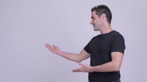 Man Presenting Product to the Left of Frame