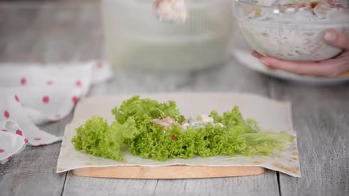 Woman is Cooking Pita Bread Roll with Chicken and Vegetables