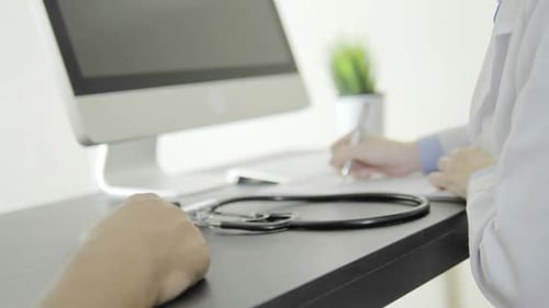 Doctor Taking Notes During Medical Examination