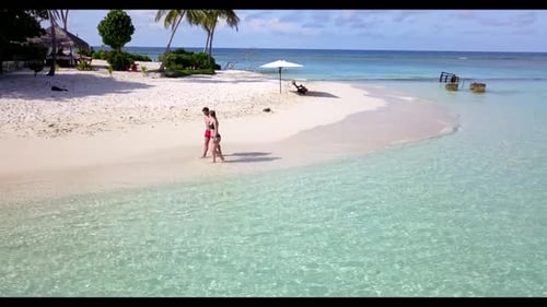 Two people relax on marine tourist beach trip by blue sea with white sandy background of the Maldive