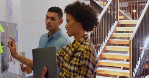 Business people discussing over chart in a modern office 4k