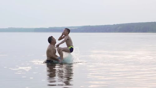Adult and Child Playing Together in the Lake