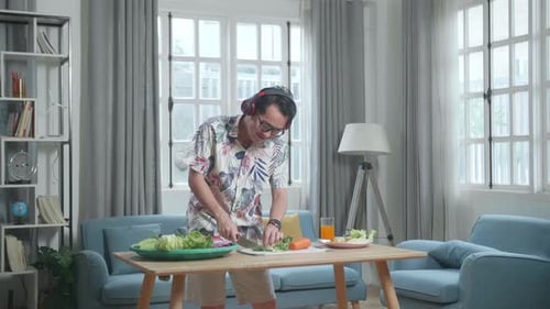 Man With Headphones Cooking Healthy Meal at Home
