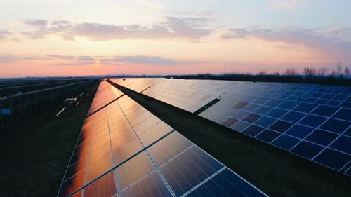 Close up Solar panels. Aerial view of Solar farm at Summer Sunset. Flying Above Solar
