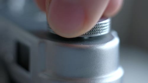 Fingers Adjusting Silver Camera Top Dial