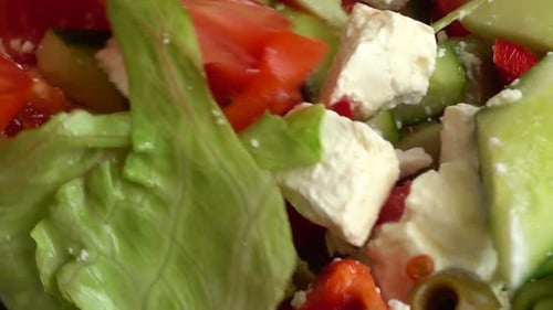 Preparing a salad in a glass bowl.