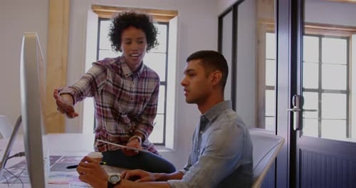 Coworkers Collaborate in Modern Urban Office Environment