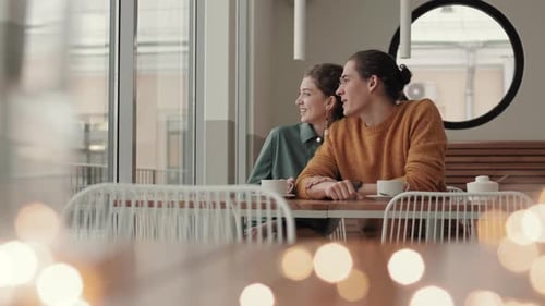 Young Man and Woman Having Pleasant Conversation in Cafe