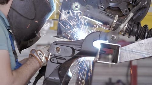 Welding Process. Worker Doing Welding Job. A Man Doing Welding Parts