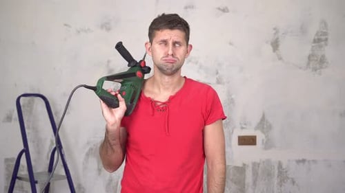 Frustrated Man with Drill Tool in Hand