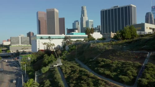 AERIAL: Flying Away From Downtown Los Angeles, California Skyline at Beautiful Blue Sky and Sunny