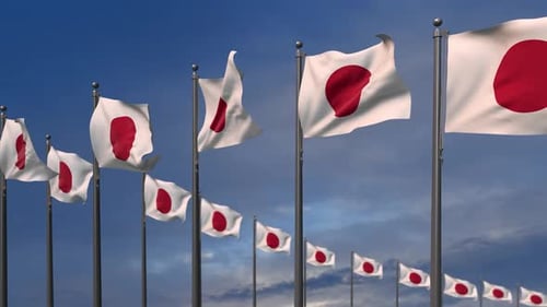 Waving Japanese Flags on Flagpoles Against Blue Sky