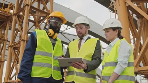 Site Supervisor Instructing Construction Workers