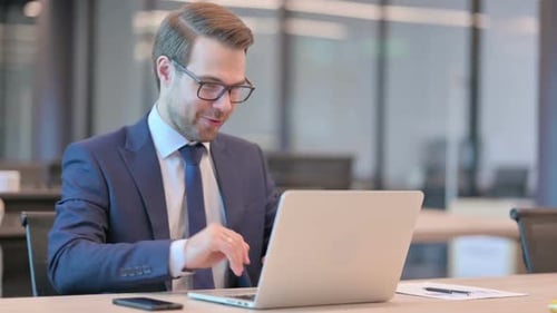 Man In Suit Having Video Conference On Laptop