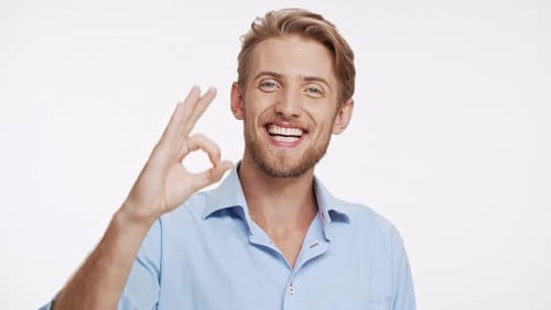 Smiling Man Makes OK Hand Gesture