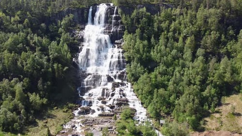 Upward moving aerial of Tvindefossen waterfall - Famous tourist attraction in Voss Norway