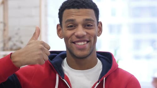 Young Adult Giving Thumbs Up Gesture