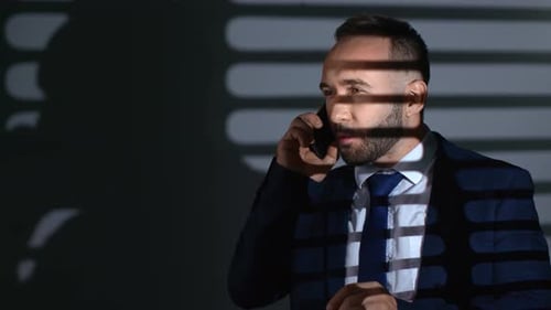 Successful Business Male Talk Smartphone Working at Dusk in Gray Room Office with Jalousie Shadow