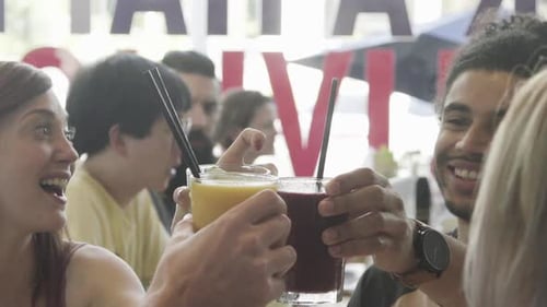 Friends clinking glasses of juice