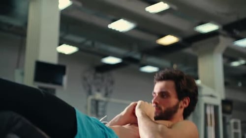 Shirtless Man Doing Sit-Ups at the Gym