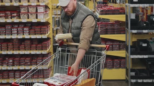 Man Shopping and Posing for Camera at Hardware Store