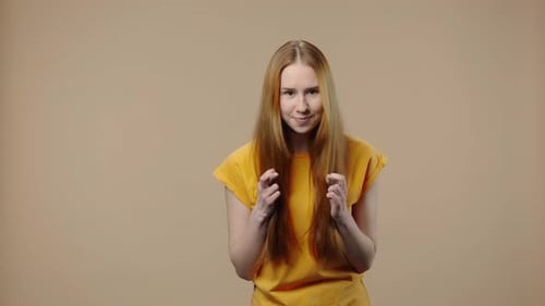 Woman Gesturing Happiness in Studio Setting