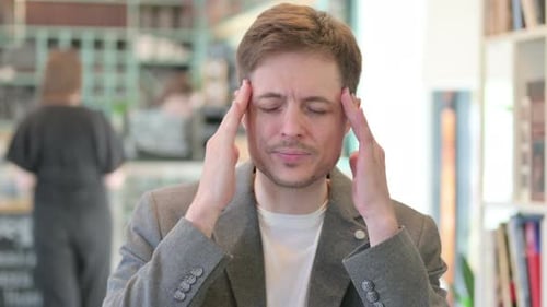 Young Man Experiencing a Headache, Close Up